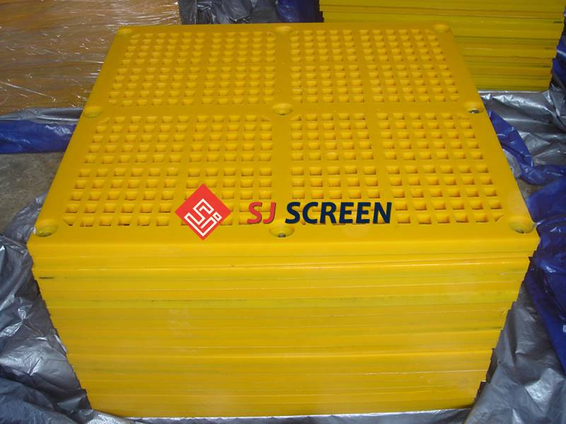 A pile of yellow tensioned polyurethane screens on the ground.